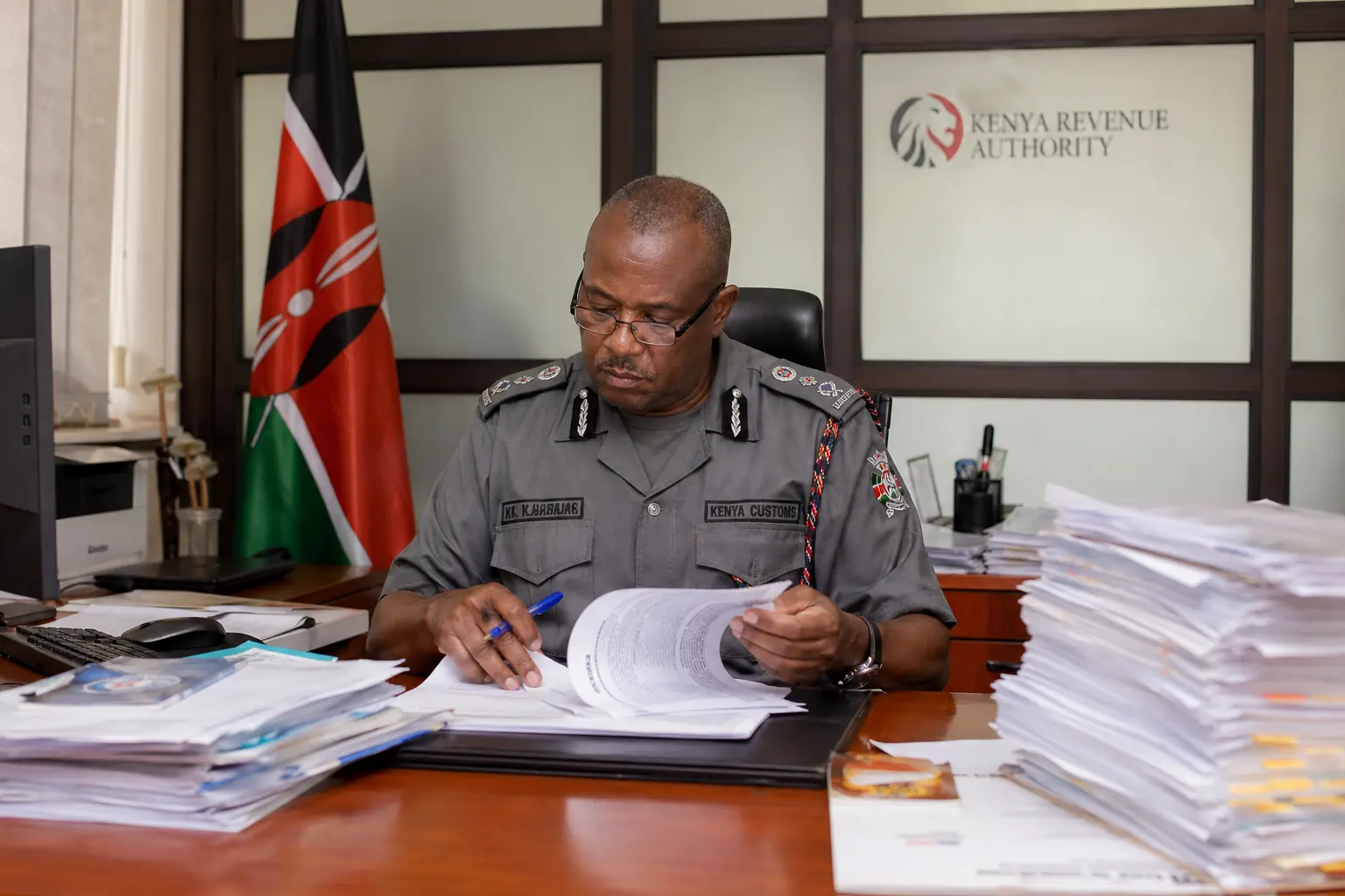 Kenya import regulations 2026: workspace at Kenya Revenue Authority office with import documents